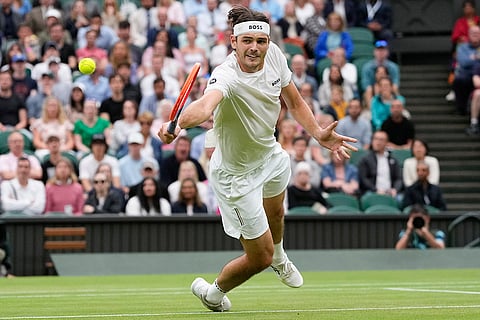 Taylor Fritz plays a backhand return to Alexander Zverev
